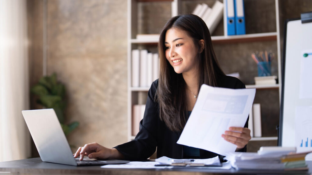 Business woman using calculator for do math finance on wooden desk in office and business working background, tax, accounting, statistics and analytic research concept.